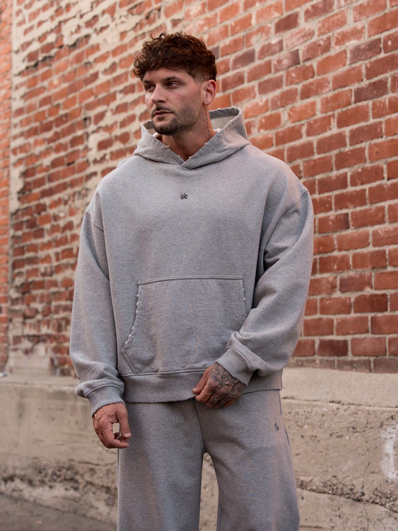 5096 - Elevated Essentials - Pullover Hoodies - Heavyweight cotton hoodie with a spacious fit, kangaroo pocket, and adjustable hood. Subtle 'Elevated' branding for a versatile, modern look in Heather Grey.