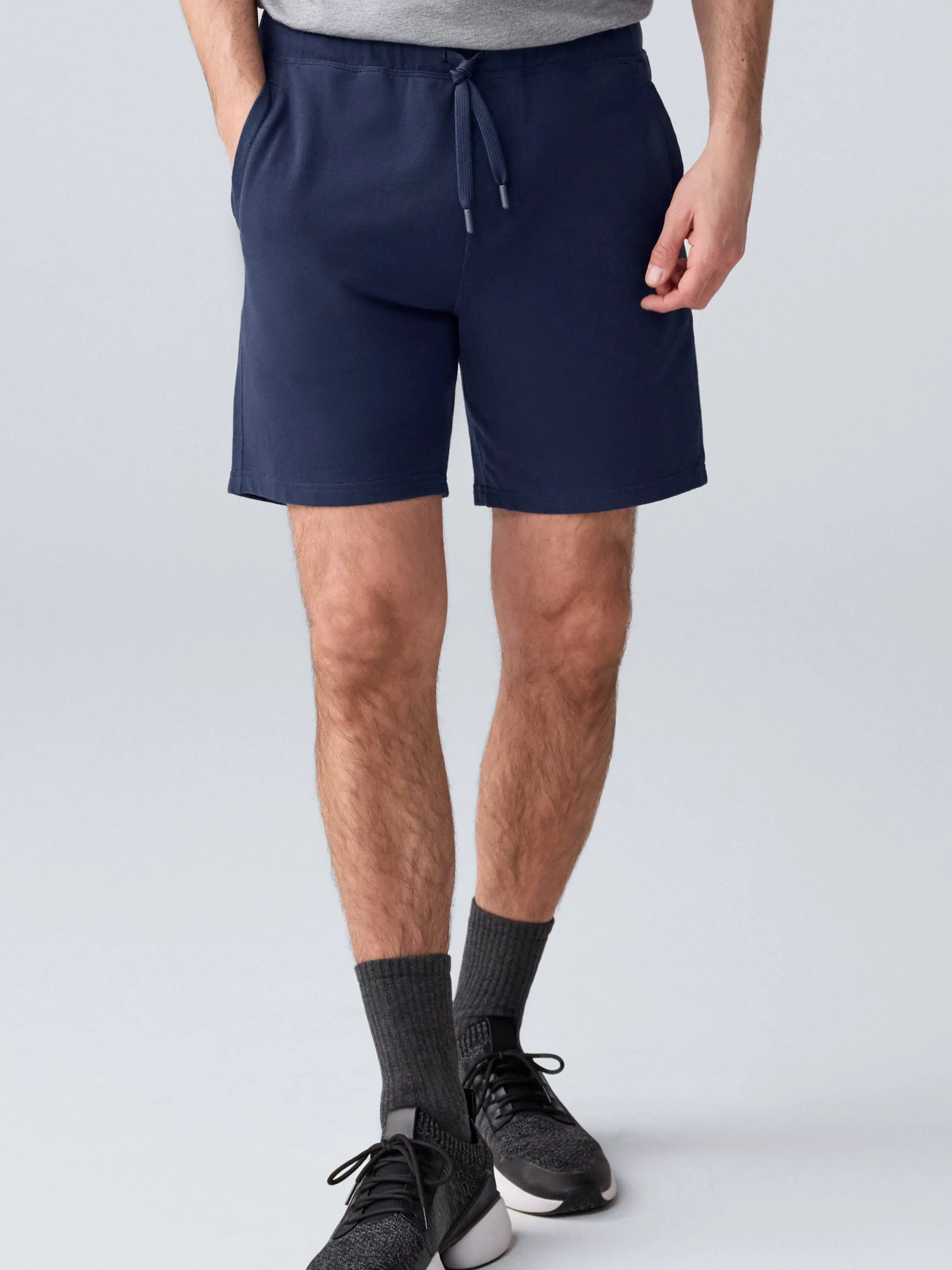 Front view of a man wearing ACE Sweatshort 7” in Total Eclipse