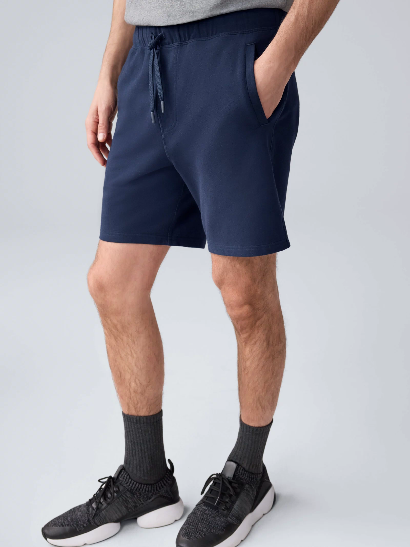 Side view of a man wearing ACE Sweatshort 7” in Total Eclipse