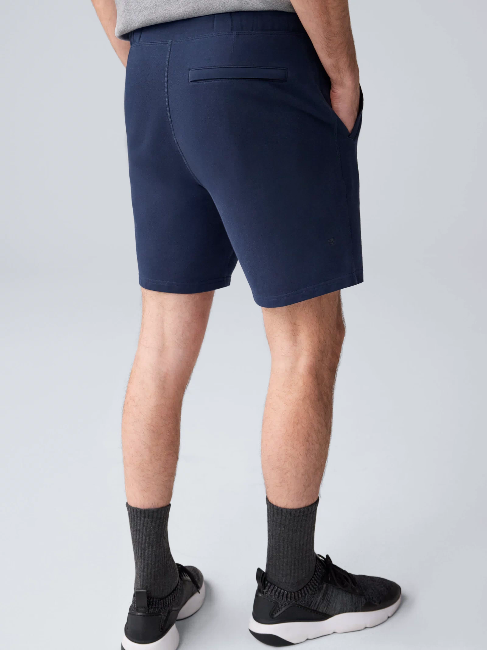 Back view of a man wearing ACE Sweatshort 7” in Total Eclipse