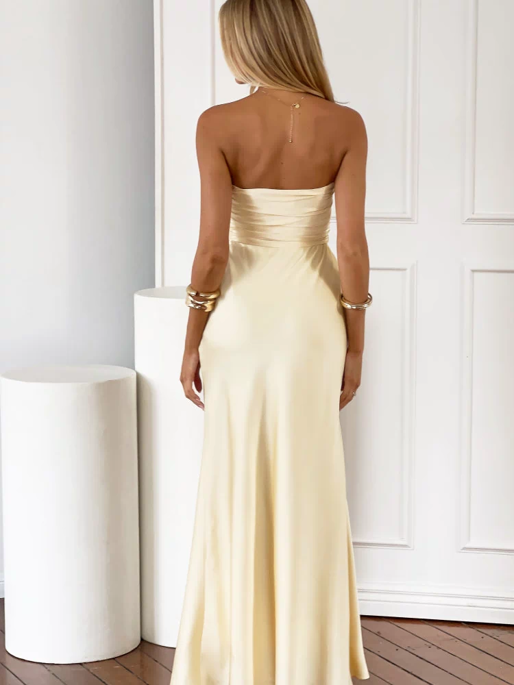 Rear view of a light yellow strapless maxi dress with a ruched detail across the back of the bodice