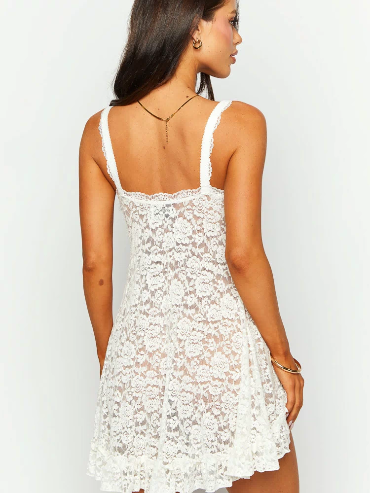 Rear view of the white lace mini dress with a square back neckline, wide lace straps, and ruffled hem
