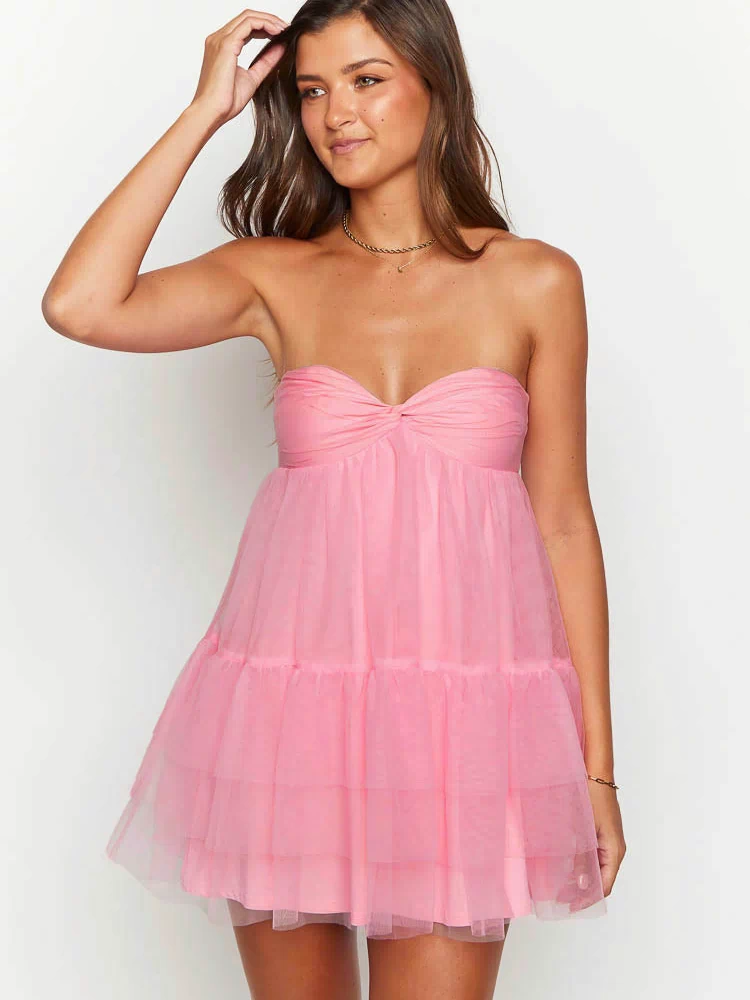 Close-up front view of a pink strapless mini dress with a twisted sweetheart neckline and tiered tulle