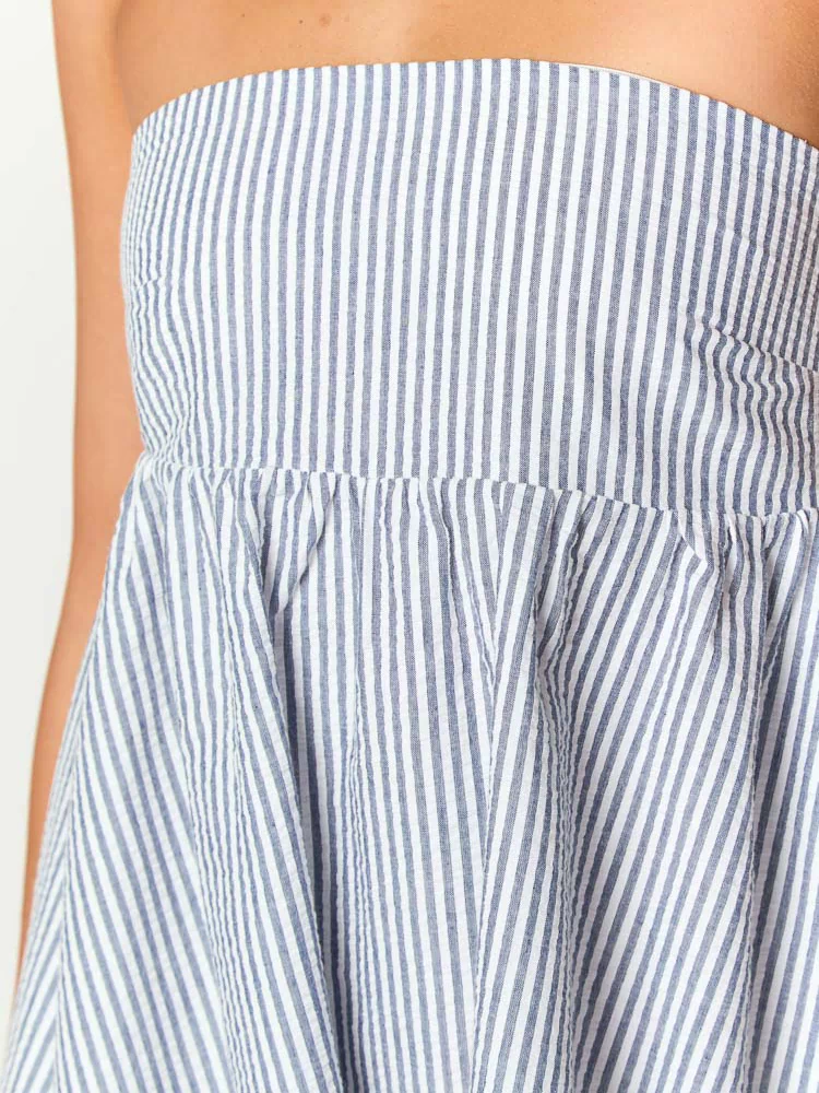 Close-up of the blue and white stripe strapless mini dress showing the gathered waist and textured fabric
