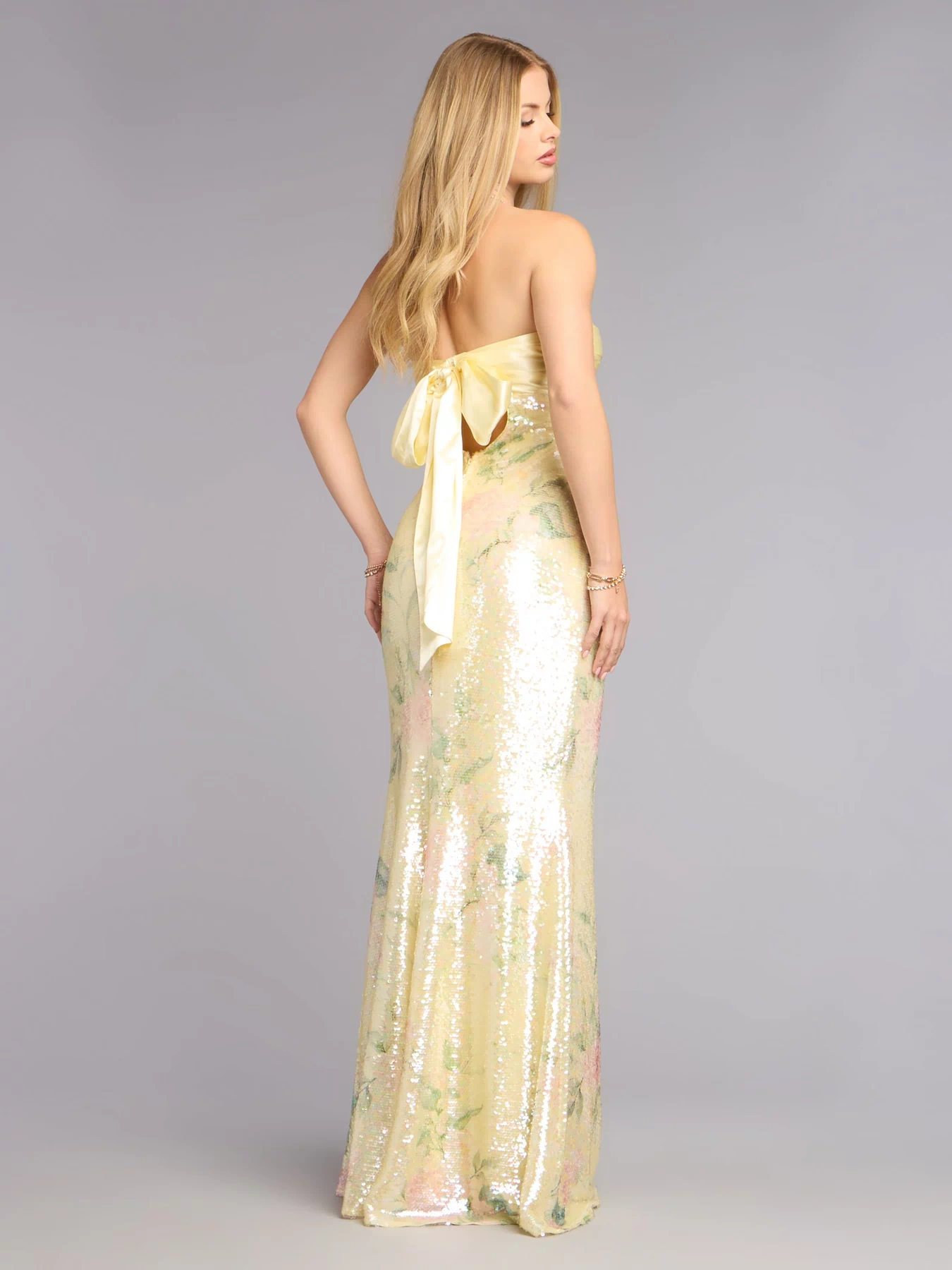 This yellow prom dress, the Angelina Satin Tie-Back Floral Sequin Formal Dress , features a sleek, floor-length design with trend-forward details that capture the excitement of Prom 2026.