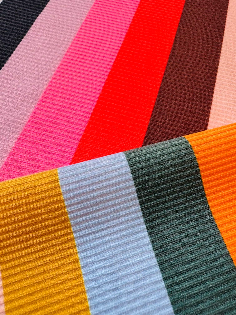 Close-up of lemlem swim ribbed fabric with multicolored stripes.