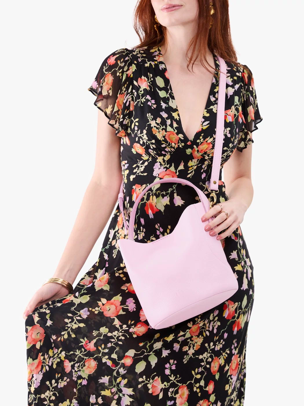 Pinkaboo*Large | Model holding symmetrical bucket bag with handle, latch closure, and removable crossbody strap