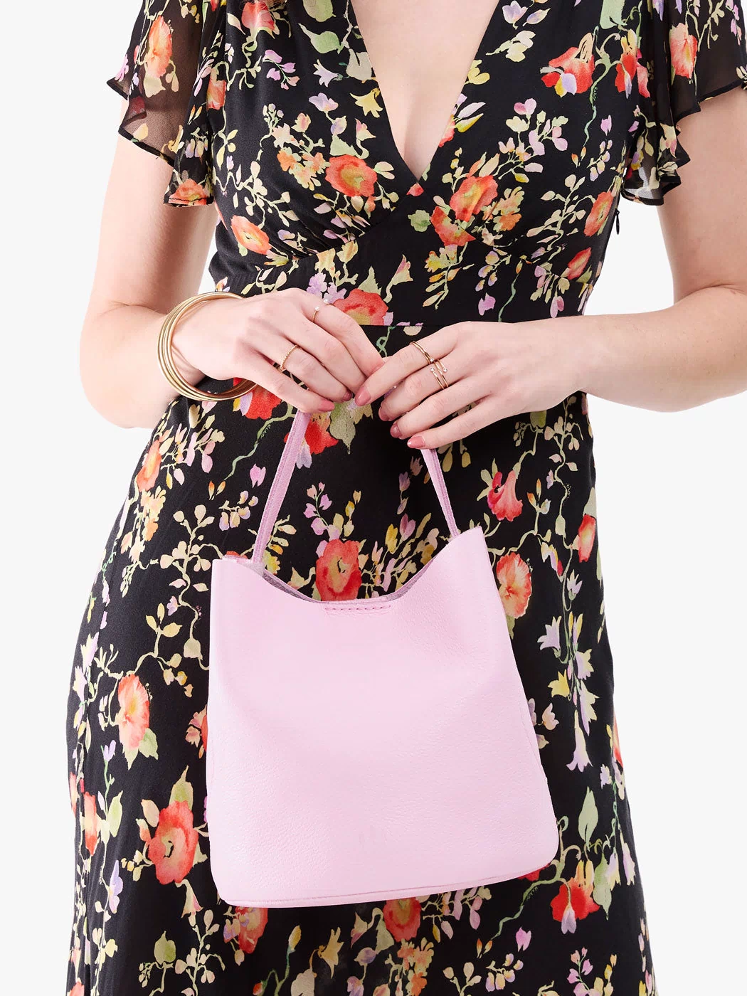 Pinkaboo*Large | Model holding symmetrical bucket bag with handle, latch closure, and removable crossbody strap