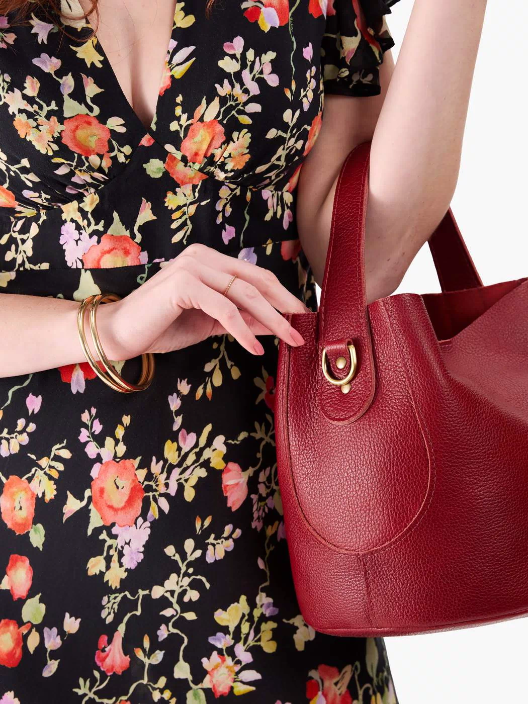 Chili Red*Large | Model holding symmetrical bucket bag with handle, latch closure, and removable crossbody strap