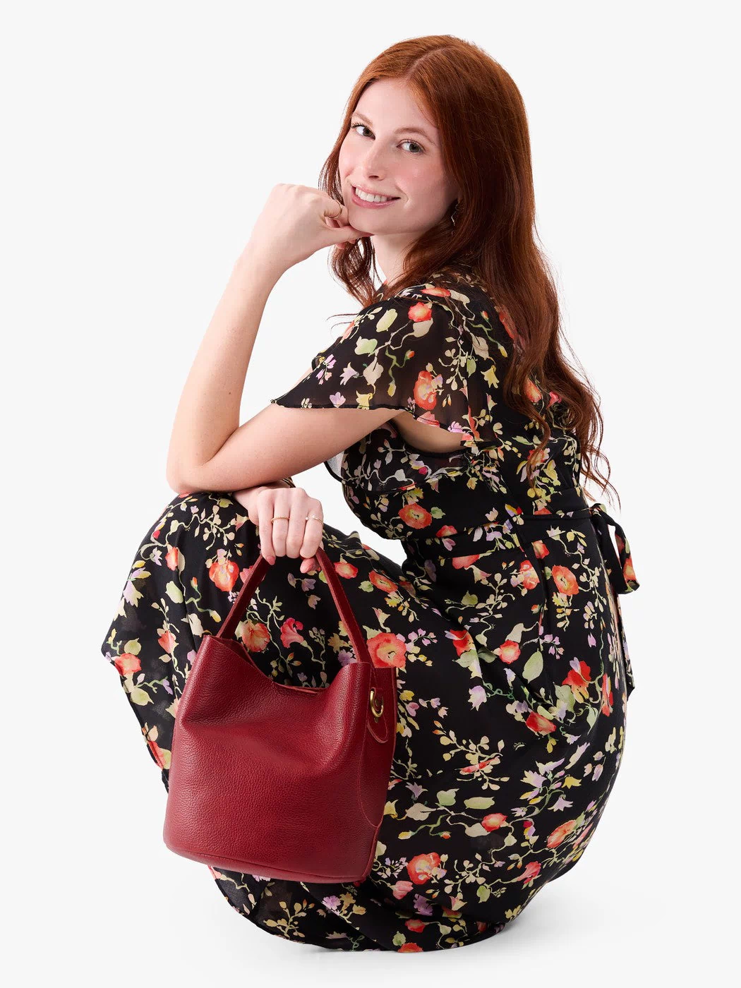 Chili Red*Large | Model holding symmetrical bucket bag with handle, latch closure, and removable crossbody strap