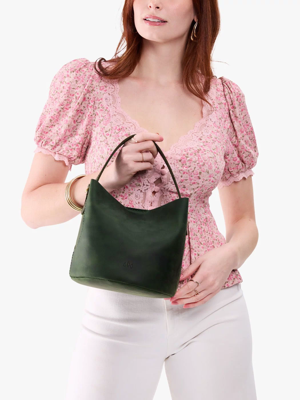 Evergreen*Small | Model holding symmetrical bucket bag with handle, latch closure, and removable crossbody strap