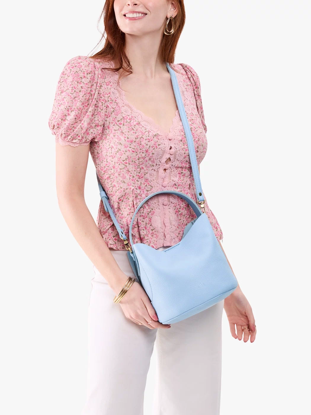 Skyway*Small | Model wearing symmetrical bucket bag with handle, latch closure, and removable crossbody strap