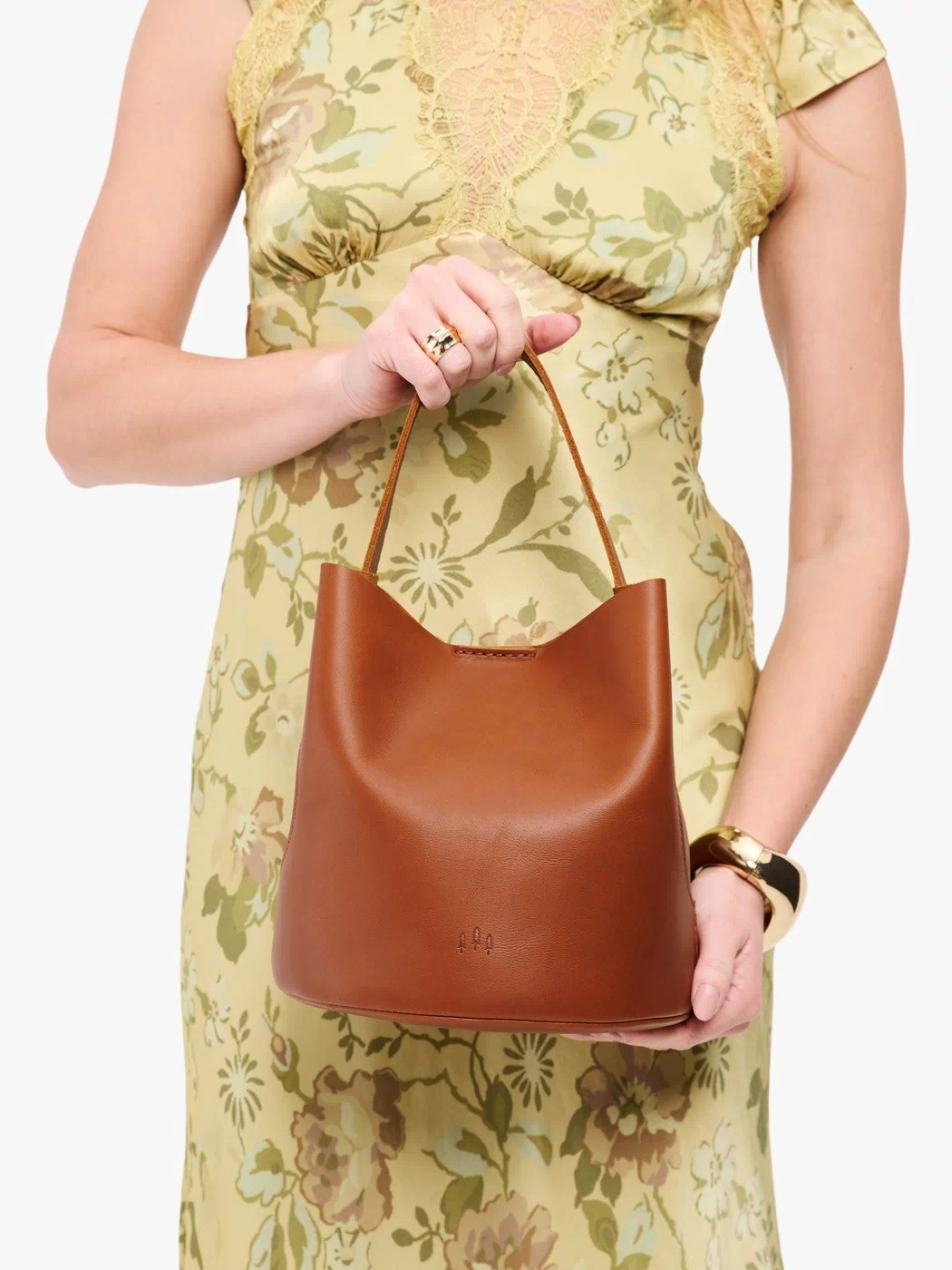 Honey*Large | Model holding symmetrical bucket bag with handle, latch closure, and removable crossbody strap
