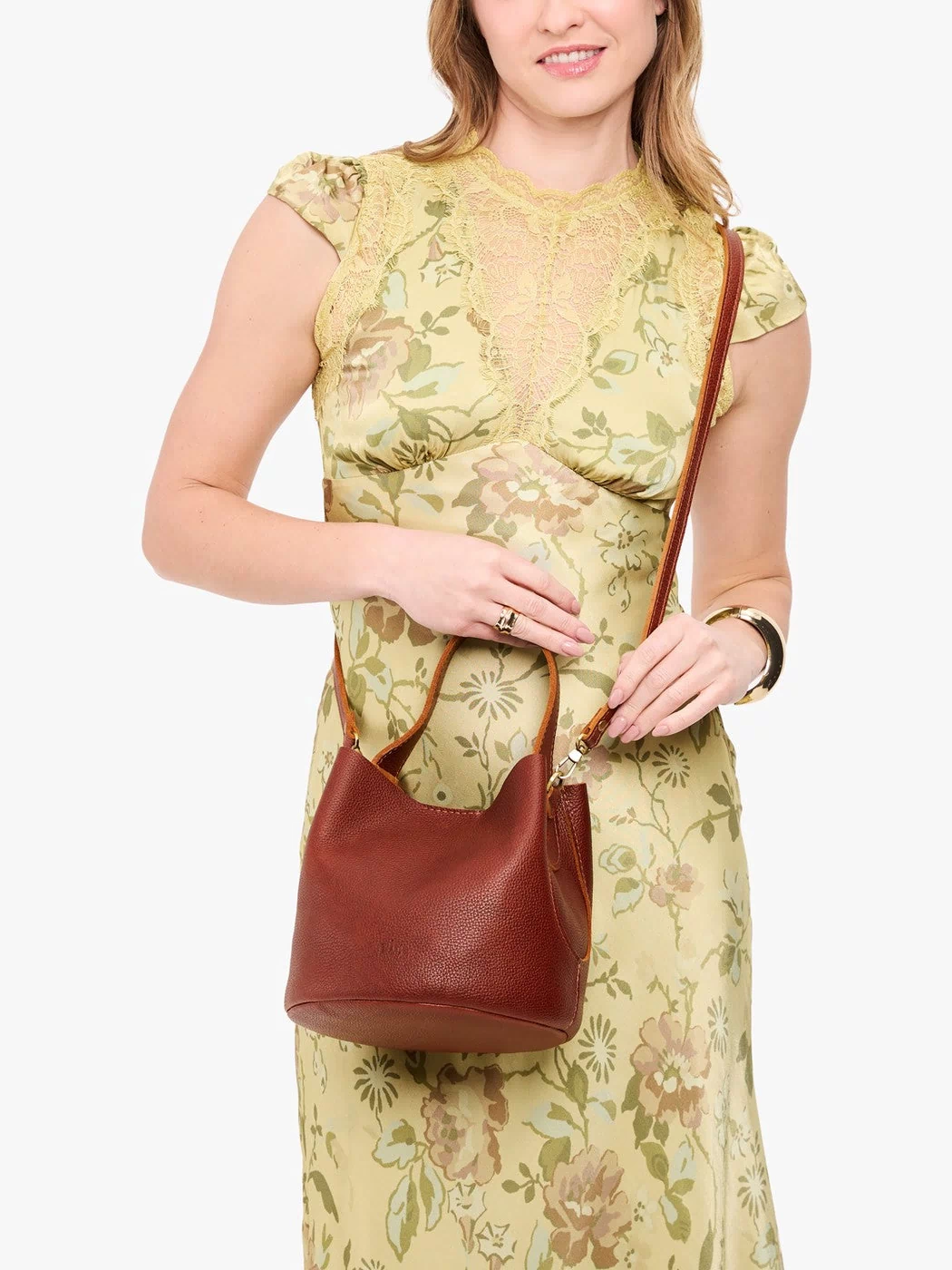 Nutmeg*Small | Model wearing symmetrical bucket bag with handle, latch closure, and removable crossbody strap