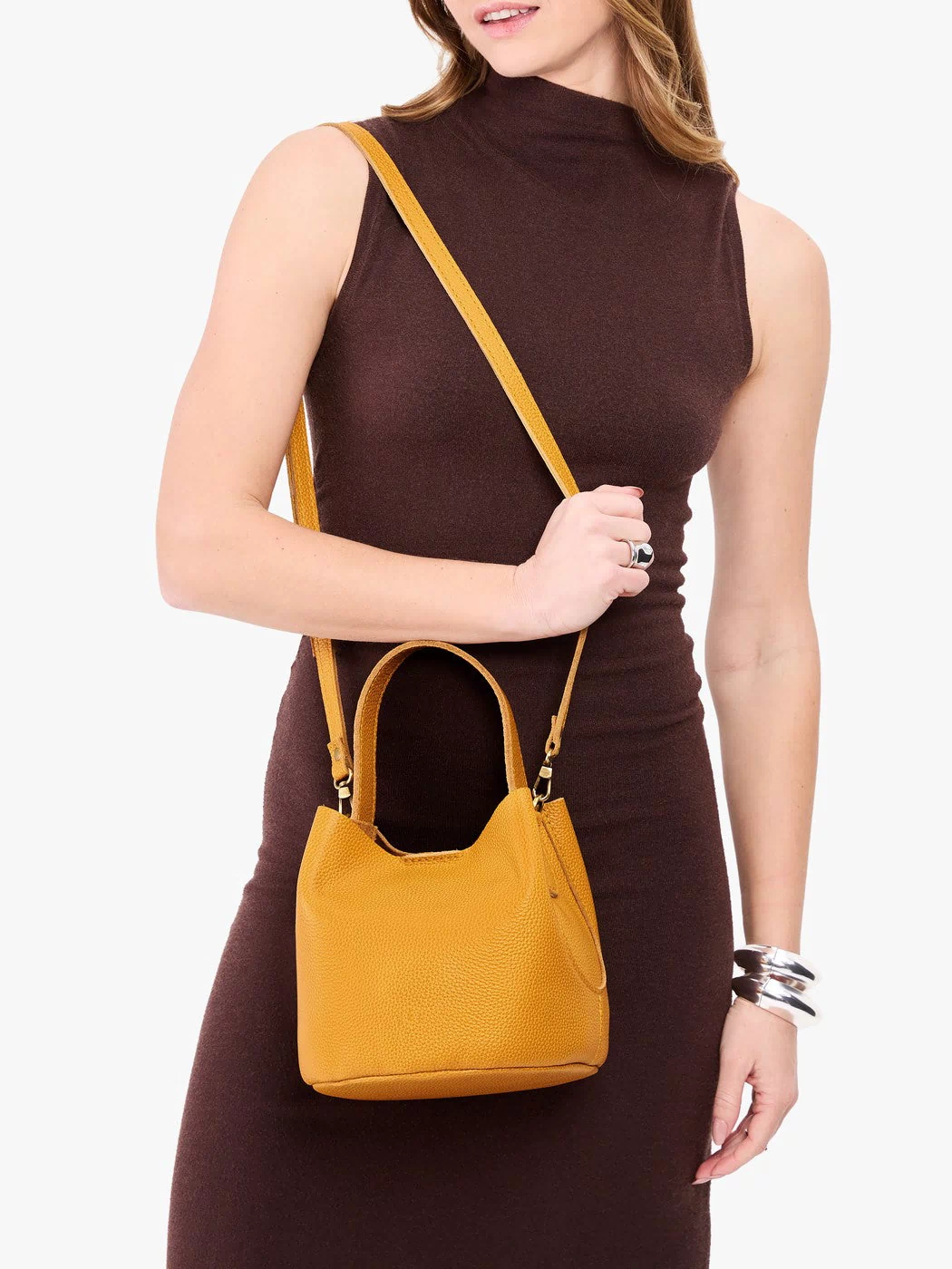 Sunshine*Small | Model wearing symmetrical bucket bag with handle, latch closure, and removable crossbody strap