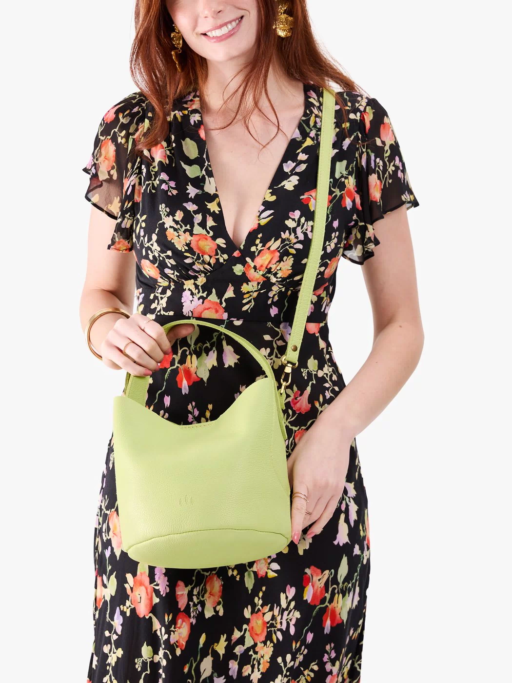 Shadow Lime*Small | Model holding symmetrical bucket bag with handle, latch closure, and removable crossbody strap