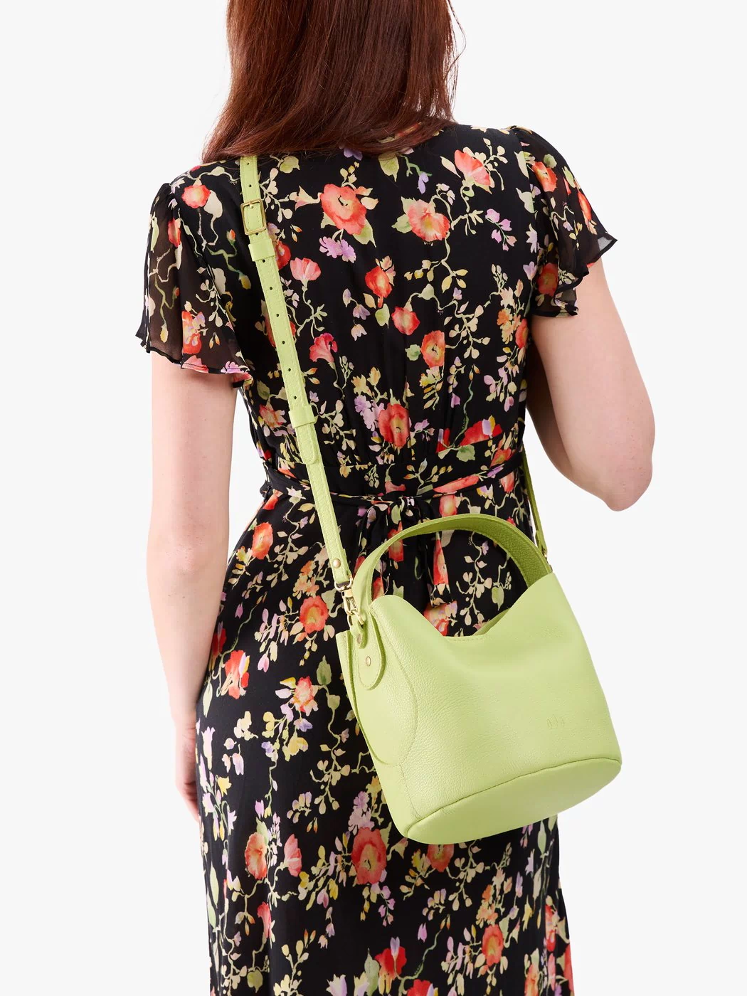 Shadow Lime*Small | Model wearing symmetrical bucket bag with handle, latch closure, and removable crossbody strap