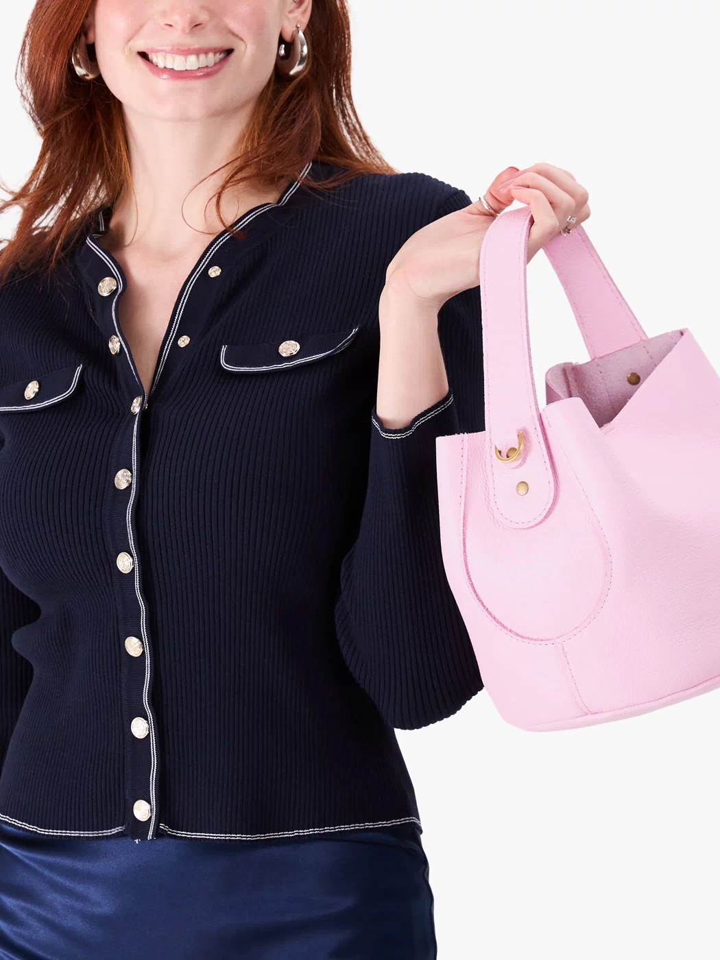 Pinkaboo*Small | Model holding symmetrical bucket bag with handle, latch closure, and removable crossbody strap