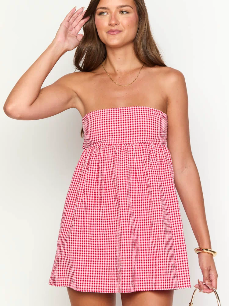 Close-up of the red gingham strapless mini dress with a gathered waist