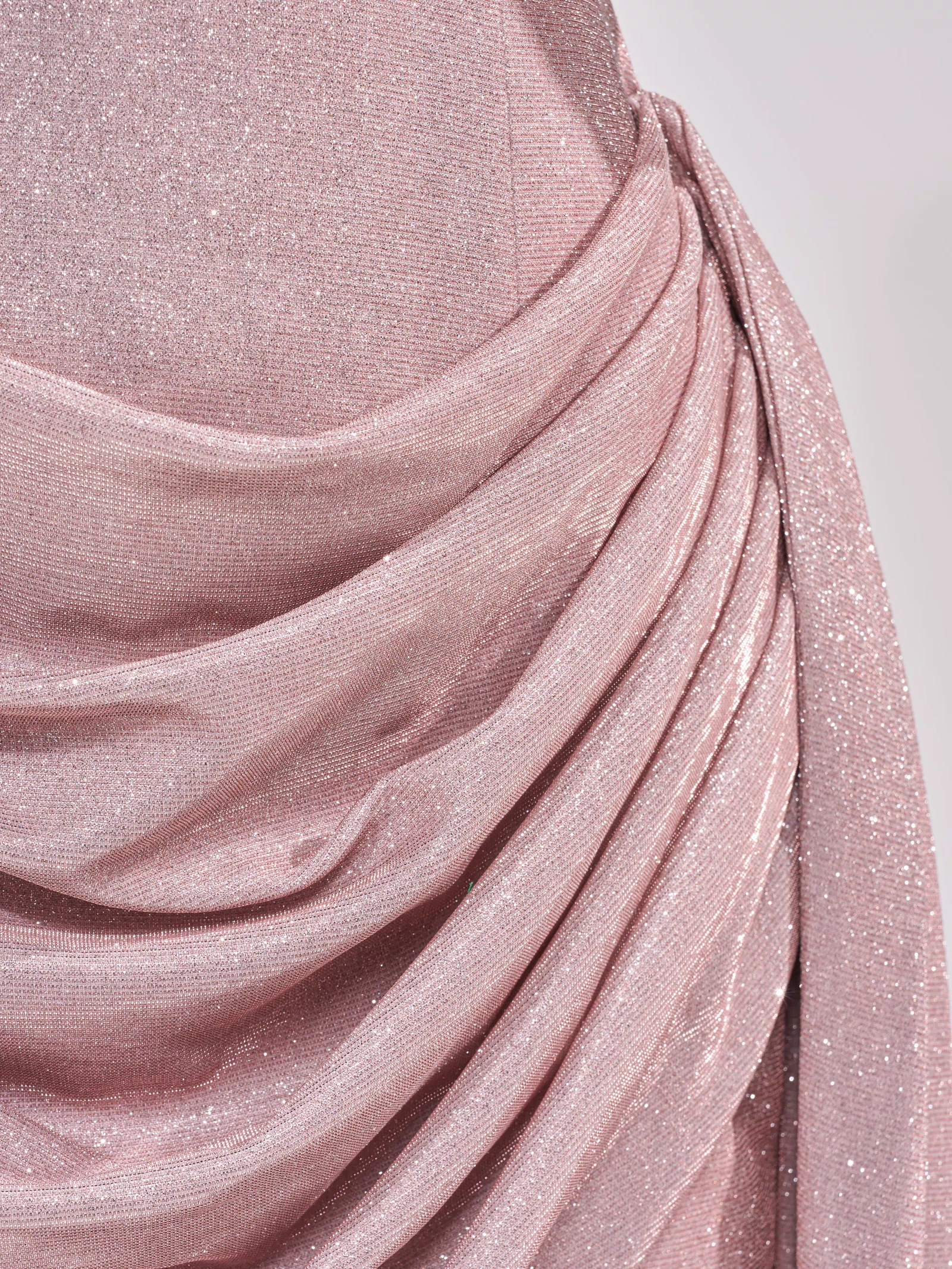 Close-up of the BEYOND CLASSY STRAPLESS SHIMMER MINI DRESS, featuring a shimmery light pink hue, ruched and draped details for elegant texture—perfect as a formal club dress.