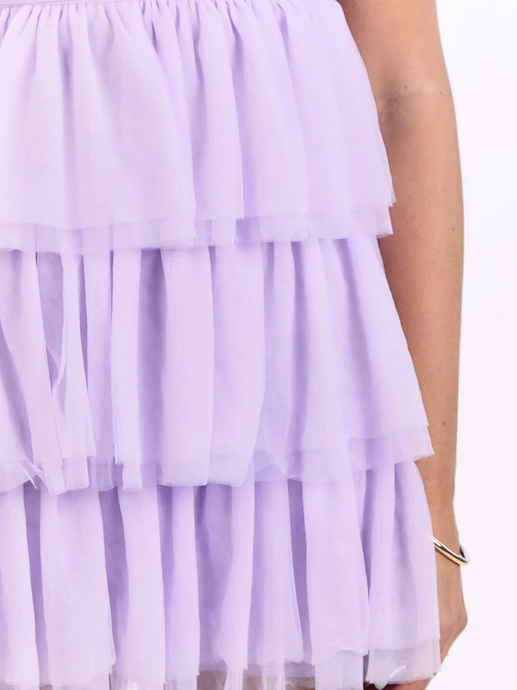 Close-up of the gathered tiered lilac tulle ruffles on the mini dress skirt