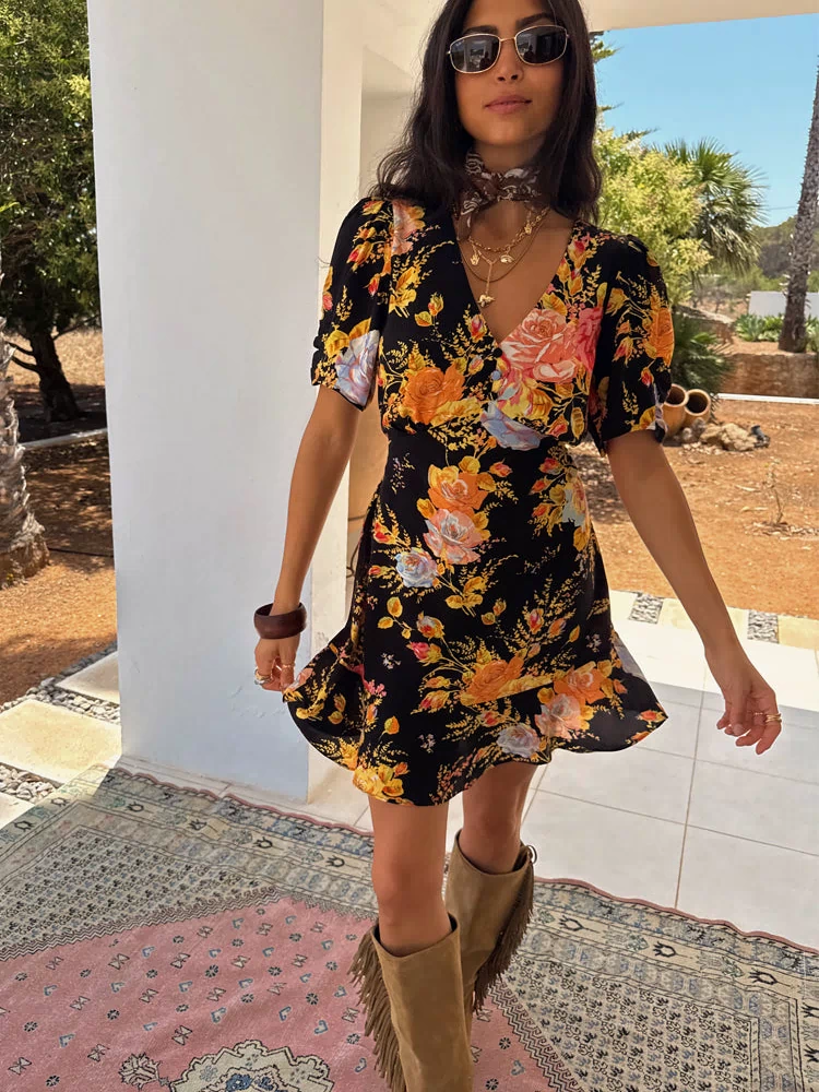 Black Sofia Mini Tea Dress with an orange and blue floral print, v-neckline and frill hem detail.