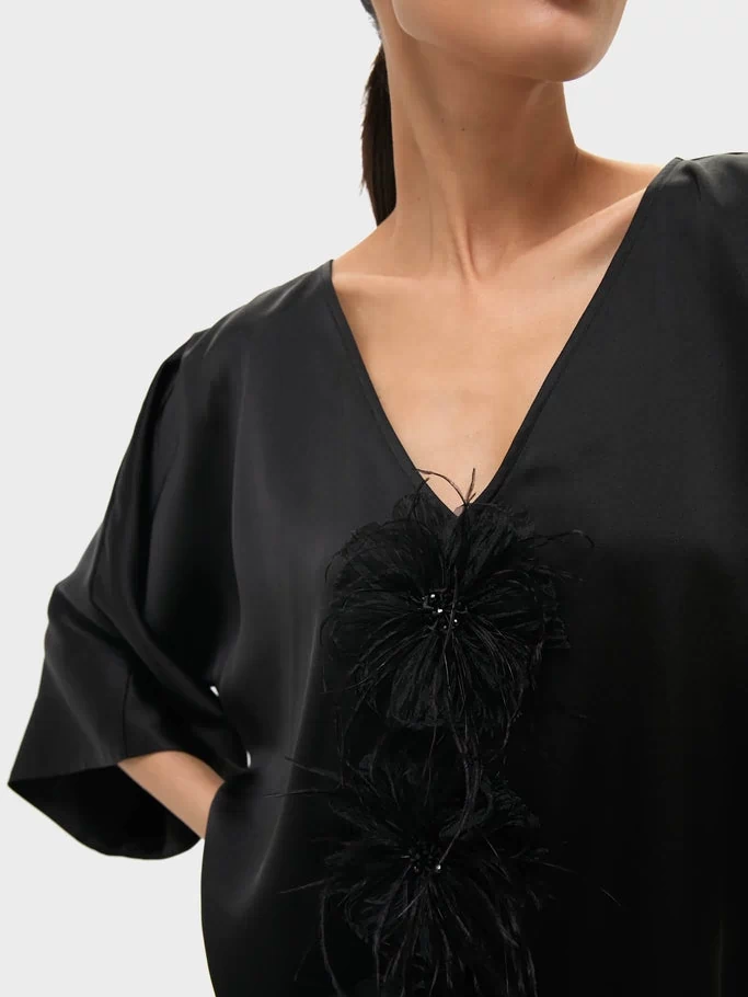 Black Satin Diane Mini Dress featuring effortless kimono sleeves and fun, high-end feather floral embellishments, embodying a classic and confident style.
