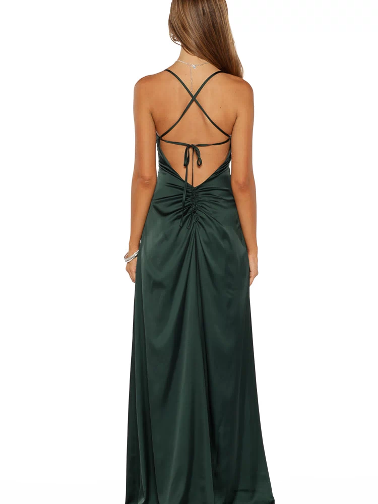 Rear view of an emerald satin maxi dress with criss-cross spaghetti straps, tie-back, and ruched detail on the lower back