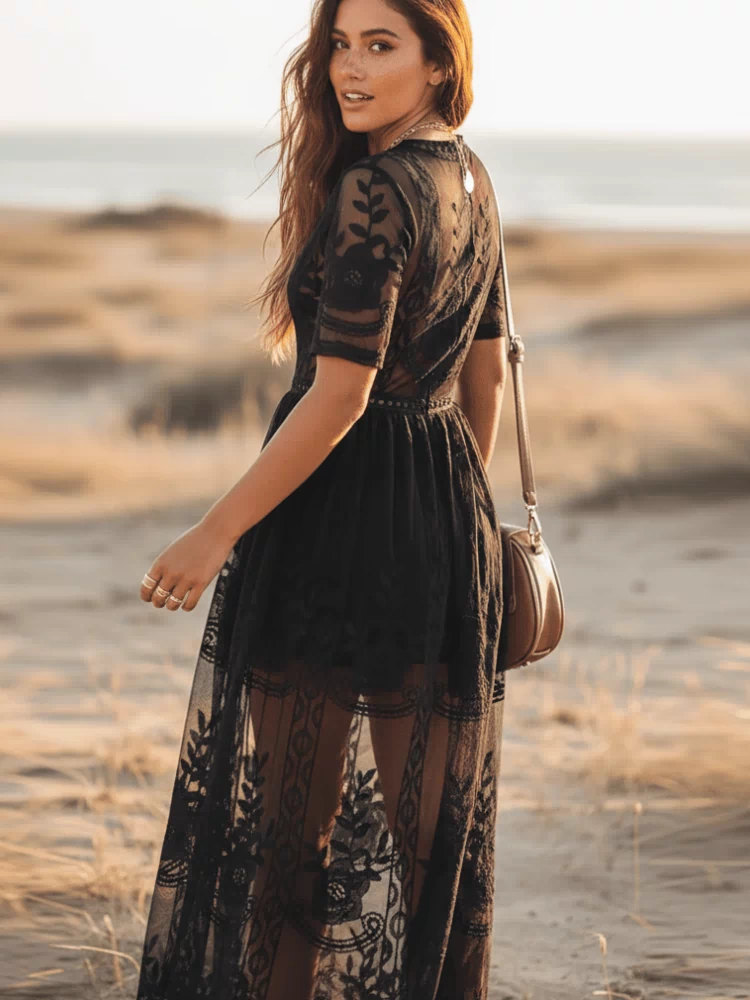 Back of black lace maxi dress with deep V-neck, sheer short sleeves, empire waist and floral lace overlay