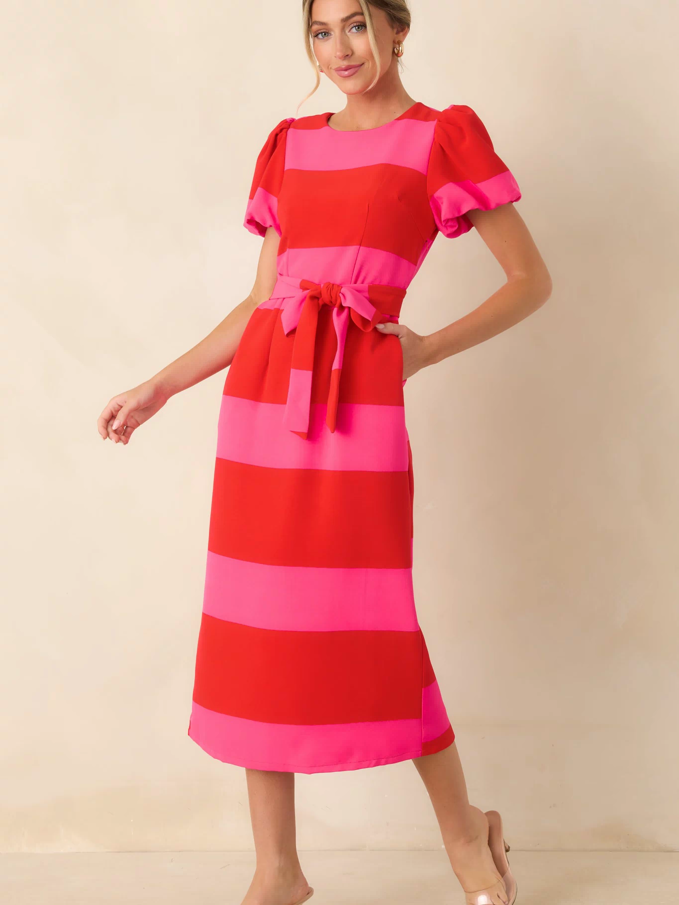 Colorful striped midi dress showcasing a fitted silhouette, short puff sleeves, and smooth woven fabric.