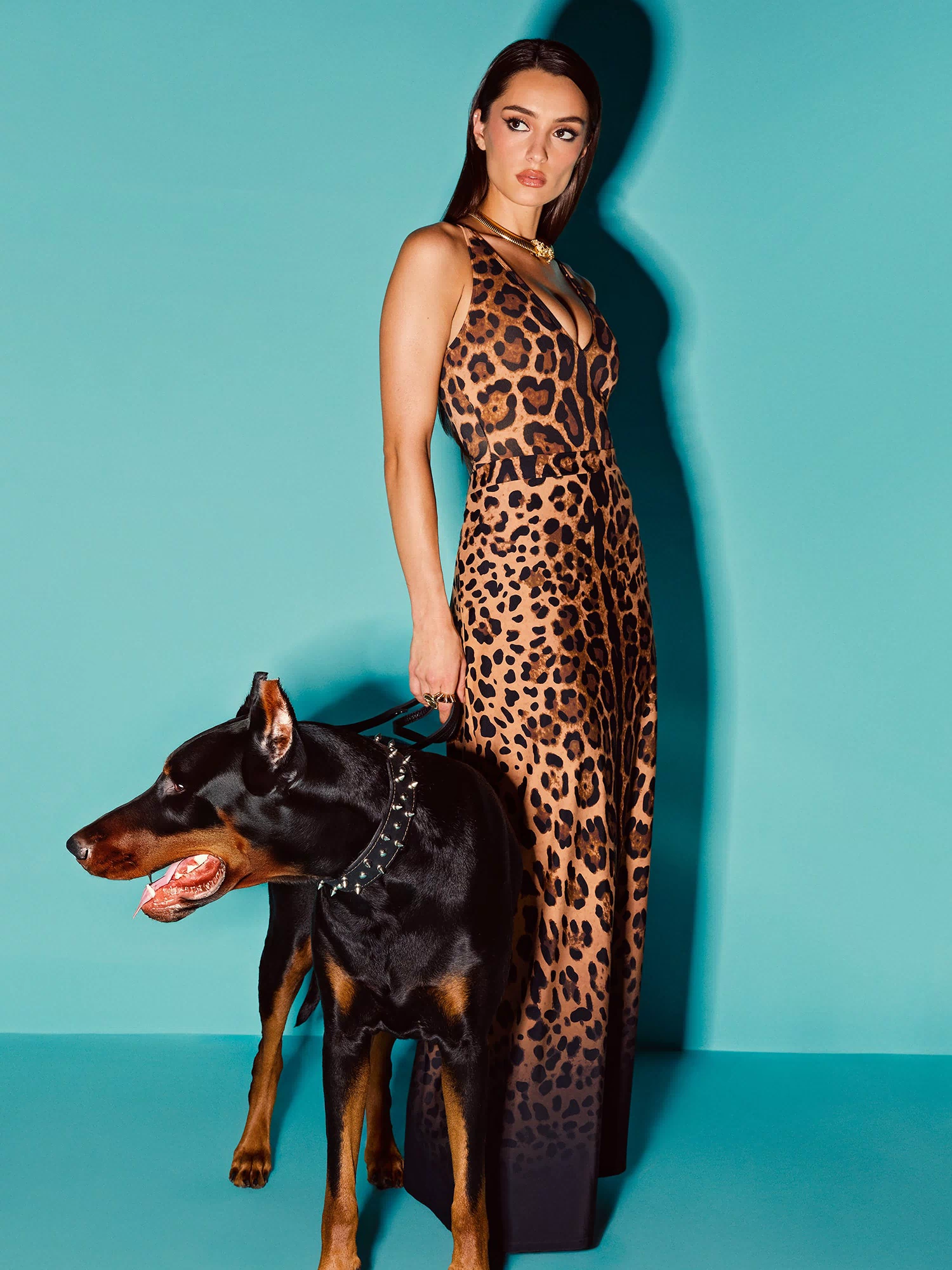 Model wears Brazilian Plungey Cheeky One Piece Shapewear Swimsuit - Symmetric Leopard and a matching skirt
