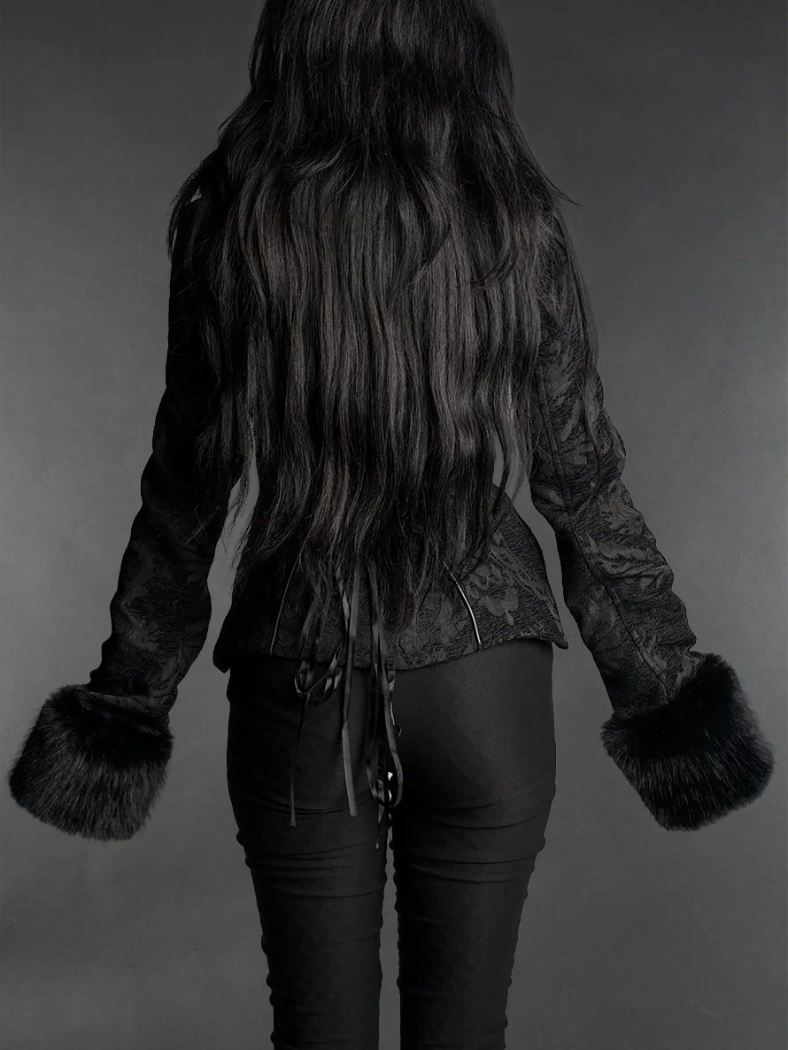 Black gothic brocade jacket with faux fur cuffs, fitted silhouette and high collar worn by a model back view
