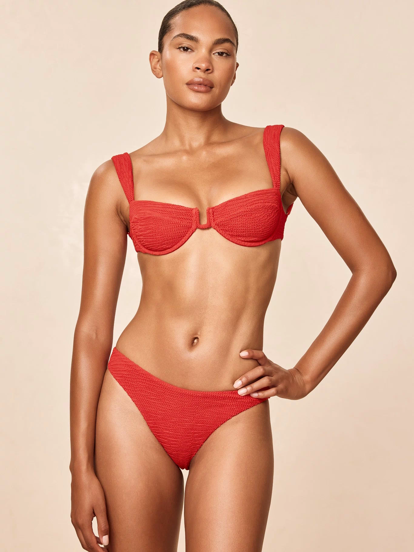 Front view of Byron Bottom in Chili Pepper Crinkle on model showing mid-rise fit, cheeky coverage and crinkle texture against a beige background
