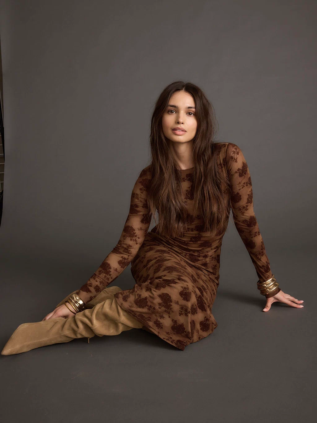 Full-length view of the brown maxi dress showing the drape and movement.