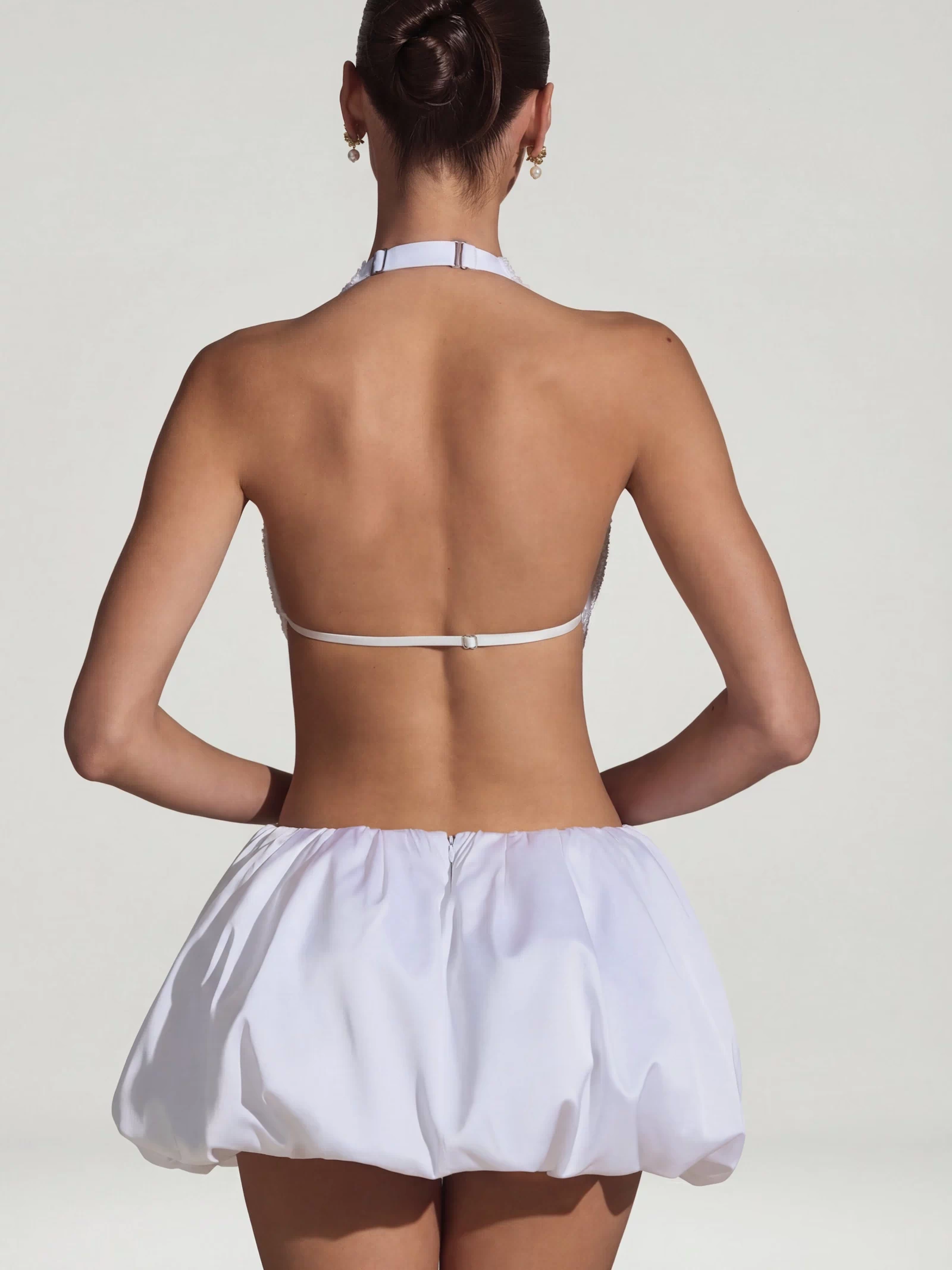 Oh Polly's Anna wearing the Cece Mini Dress in White Embellished, Recycled Satin fabric perfect for summer garden parties