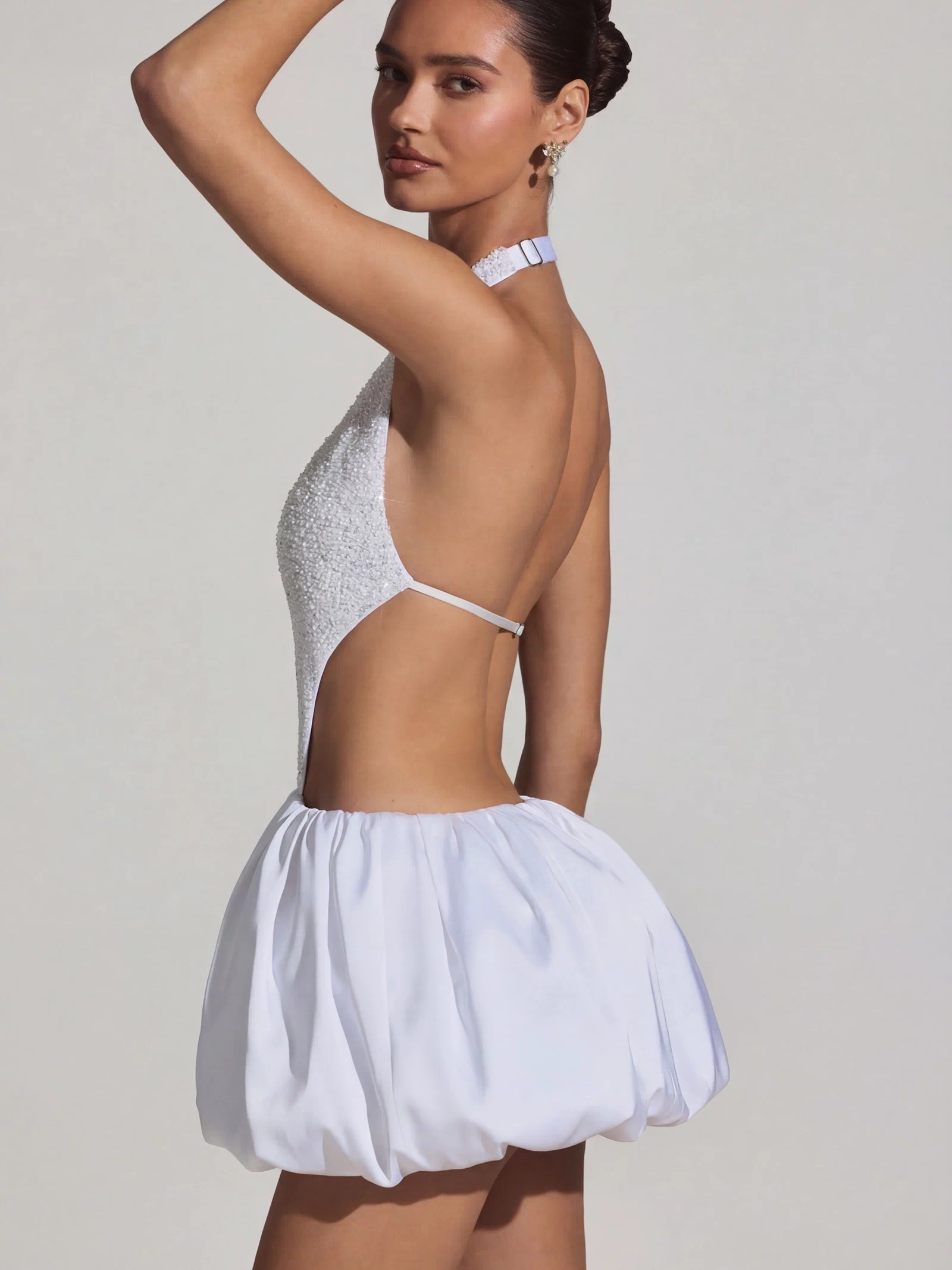 Oh Polly's Anna wearing the Cece Mini Dress in White Embellished, Recycled Satin fabric perfect for summer garden parties