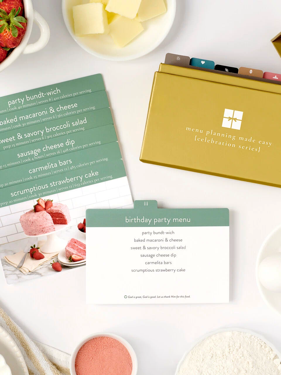 celebration menu box with photos and cards laid out