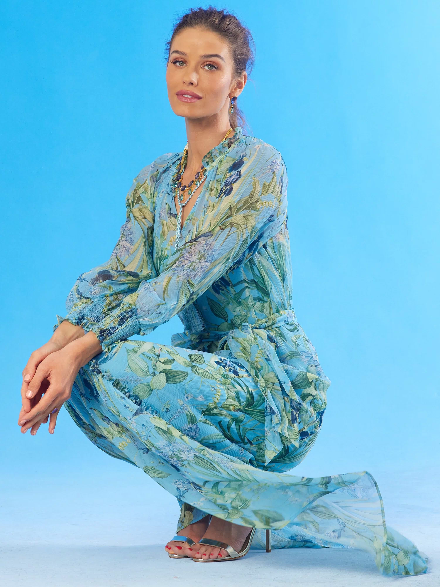 Celine Maxi Crinkle Chiffon Dress in Magical Garden-crouching with the skirt blowing in the wind