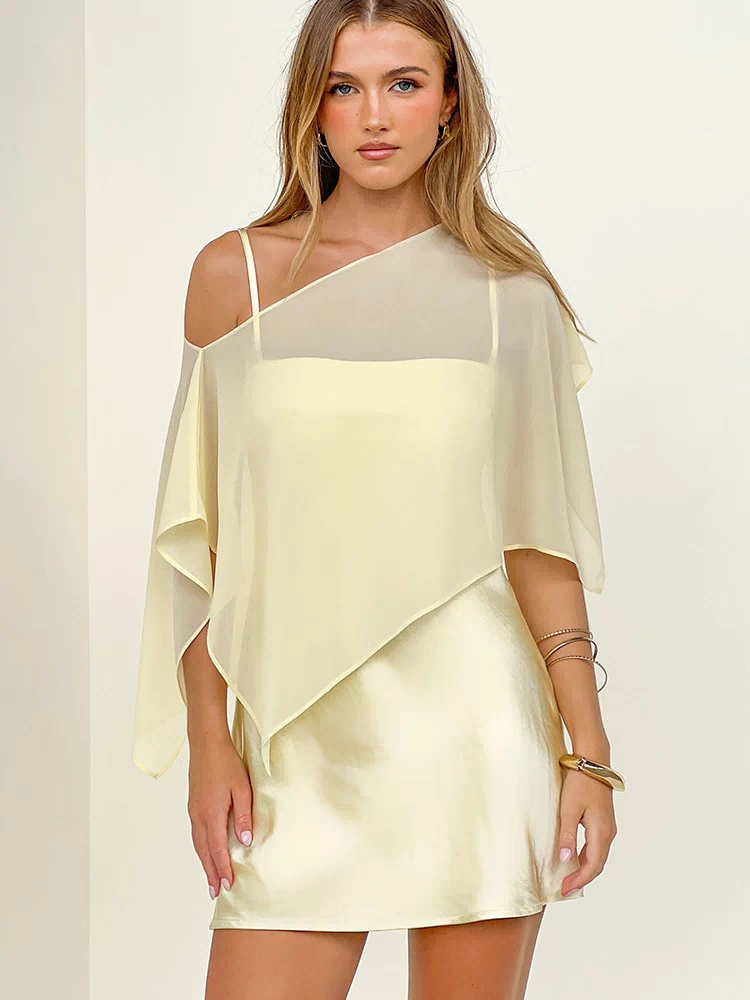 Yellow satin mini dress with a sheer asymmetric draped overlay and thin spaghetti straps
