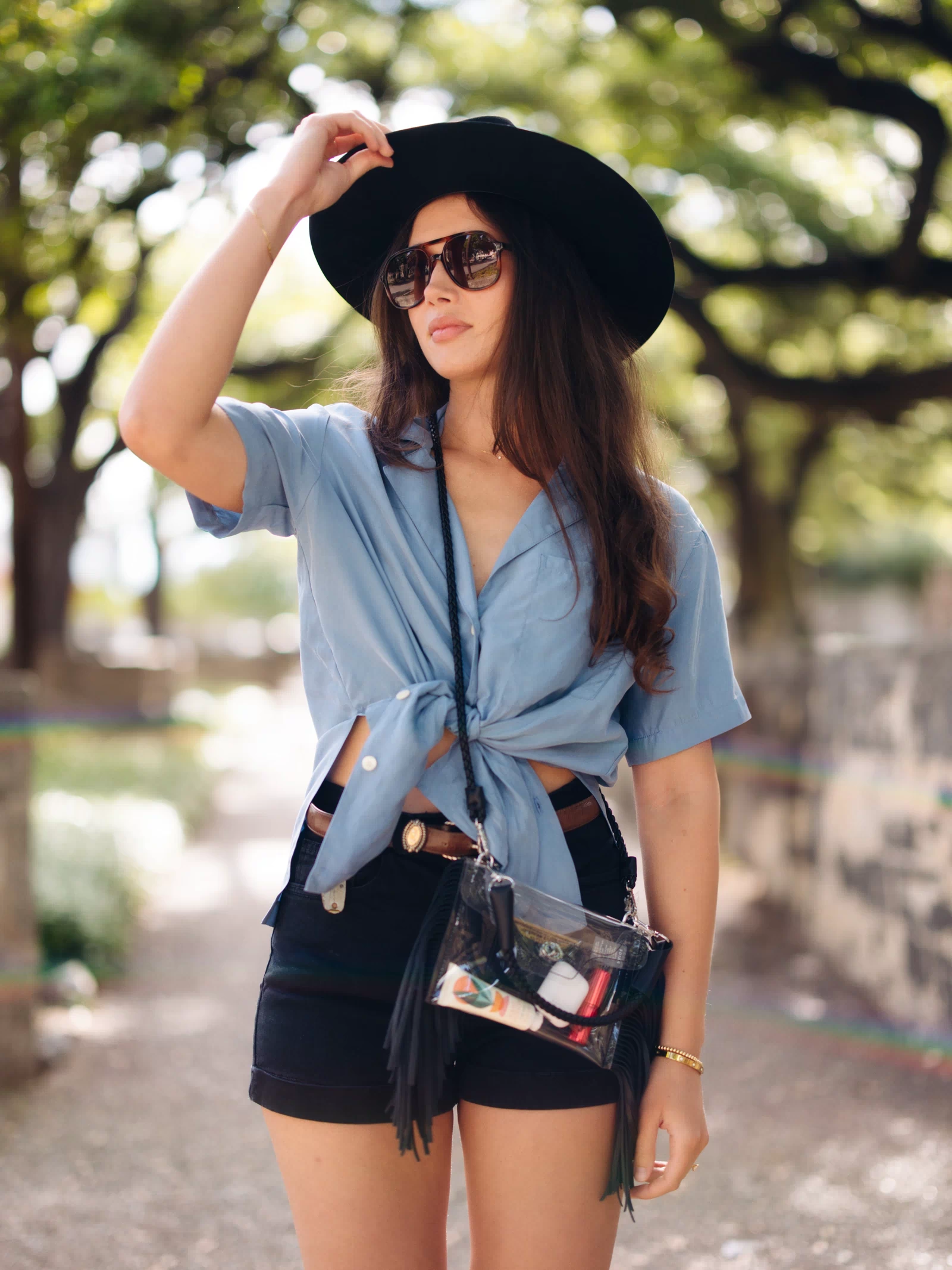 Woman wearing a concert outfit with a black Clear Fringe Crossbody - Margo Paige