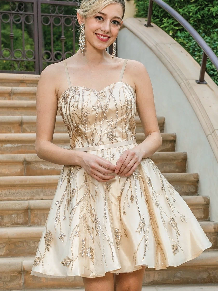 A woman wearing the Glitter-Print A-Line Short Homecoming Dress stands on outdoor stone steps, smiling at the camera.