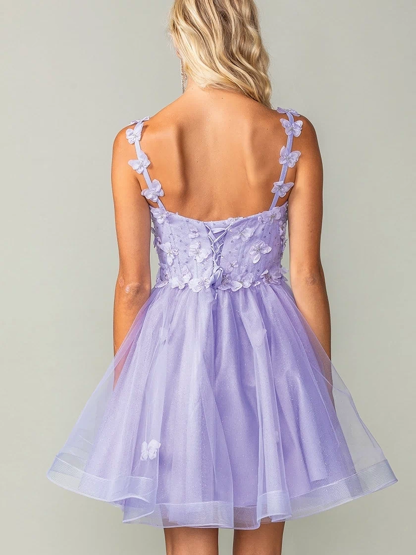 A woman with blonde hair is seen from the back wearing the Lace-Up Short Butterfly Homecoming Dress 3369, a sleeveless light purple semi-formal knee-length dress with delicate floral embellishments, set against a plain background.