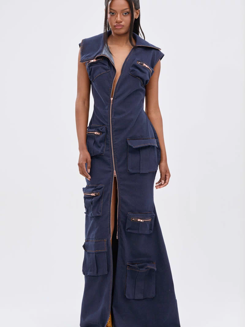 A woman wears the DONT MESS WITH ME COLLARED DENIM MAXI DRESS, featuring dark wash denim, a front zipper, and multiple utility pockets. She has long straight hair and a neutral expression against a plain white background.