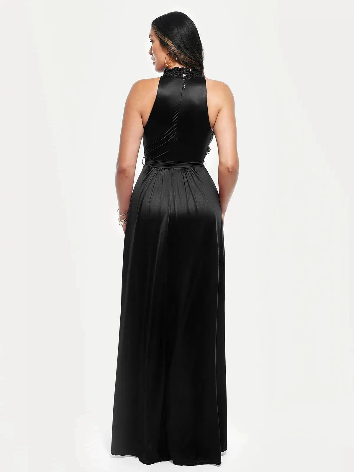 Woman wearing a black draped high neck floral-print maxi dress, showcasing its A-line skirt and high slit.