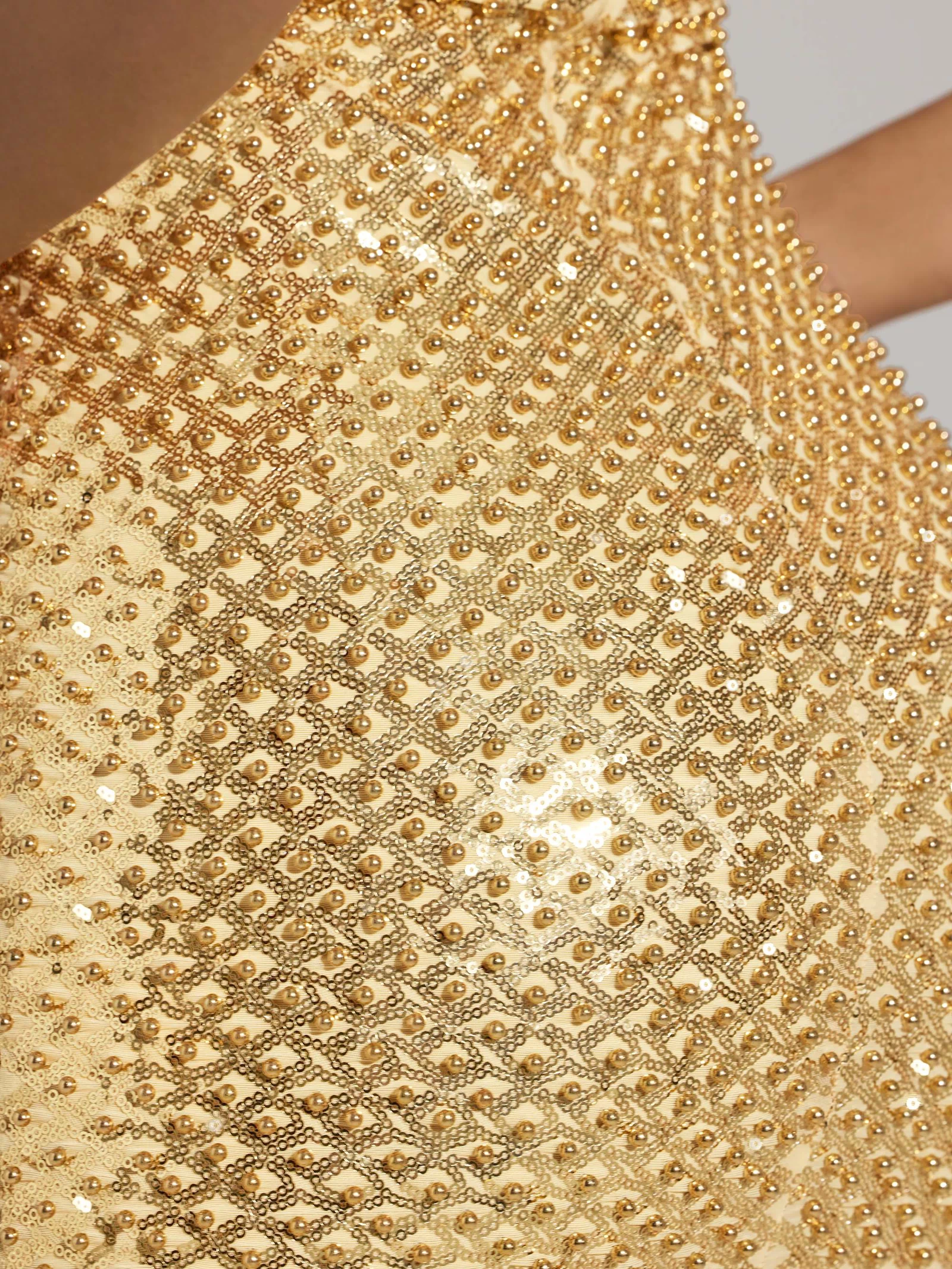 Oh Polly model Sofia wearing the Drop A Glint Mini Dress in Gold Embellished fabric perfect for clubbing nights