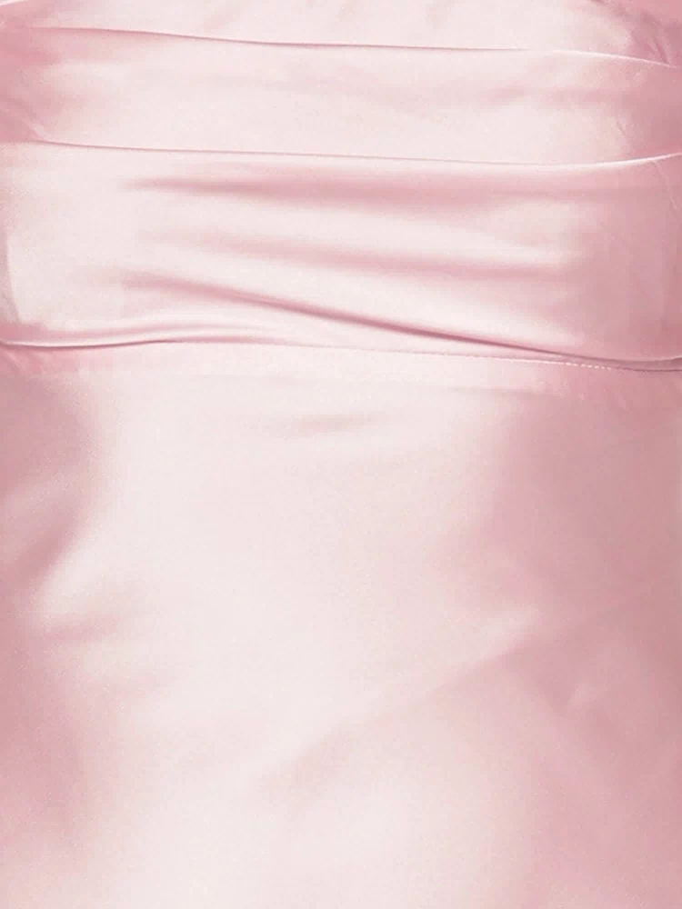 Close-up of the light pink satin fabric with subtle ruching detail on the bodice of the maxi dress