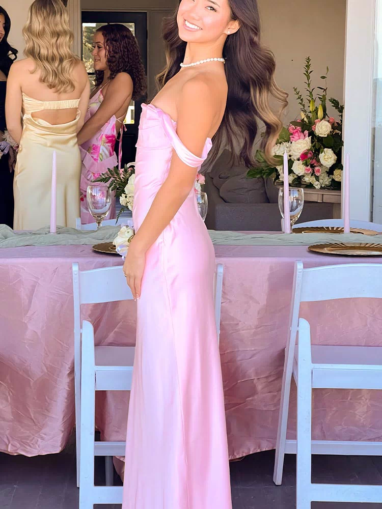 Side view of the light pink off-shoulder maxi dress showing the fitted bodice and flowing skirt