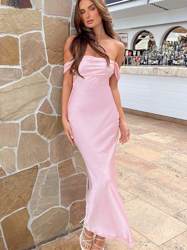 Full length view of a light pink off-shoulder satin maxi dress with a fitted bodice and flowing skirt