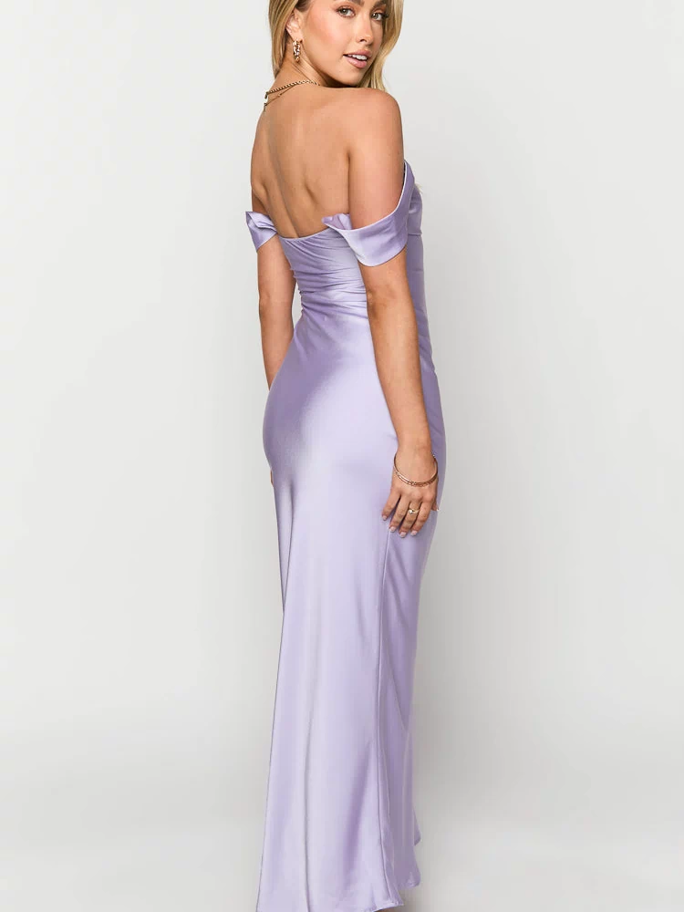 Side view of a lilac off-shoulder maxi formal dress with a fitted bodice and flowing skirt, showing the bare back