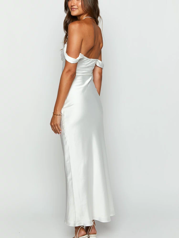 Rear-side view of a white satin off-shoulder formal dress showing the draped sleeves and flowing maxi skirt